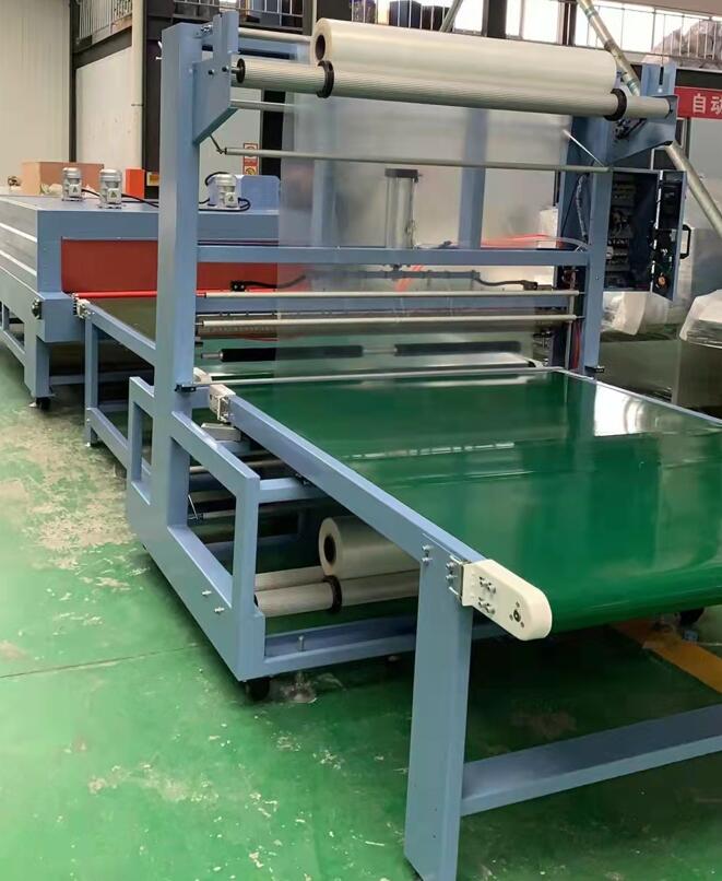 Shrink wrapping machine